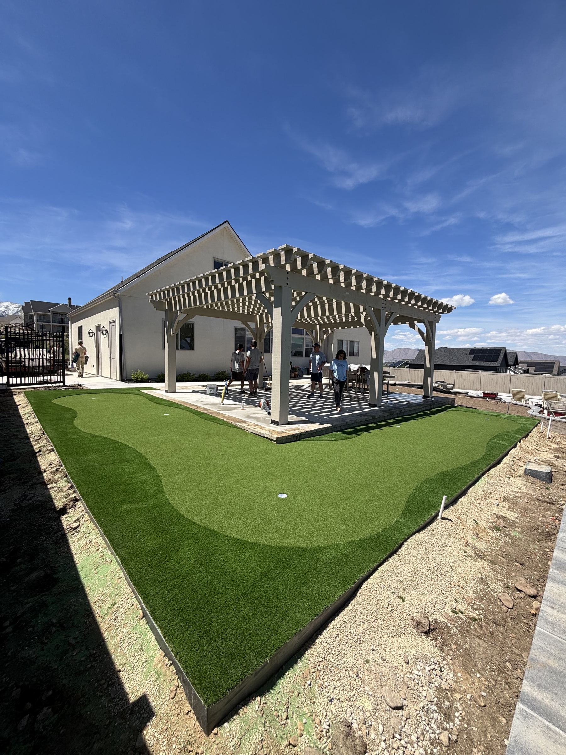 Putting green beneath a large pergola patio
